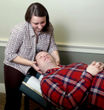 photo of the doctor working on a male who is lying on his back