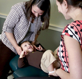 photo of a female doctor and another female with a small child between them